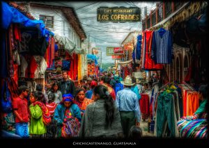The market in Chichicastenango, Guatemala is quite an event. Lots of crafts, lots of people, lots of tourists, and you'll get pushed around if you obstruct the flow. ISO 100, 47mm, f9, 1/250. Tonemapped in Photomatix details enhancer. Imagenomic noise reduciton. Nik Pro Contrast, Tonal Contrast, and Viveza to brighten the big sign and recover some of th ealmost burnt out spots. Slight Nik Glamour Glow at the end.